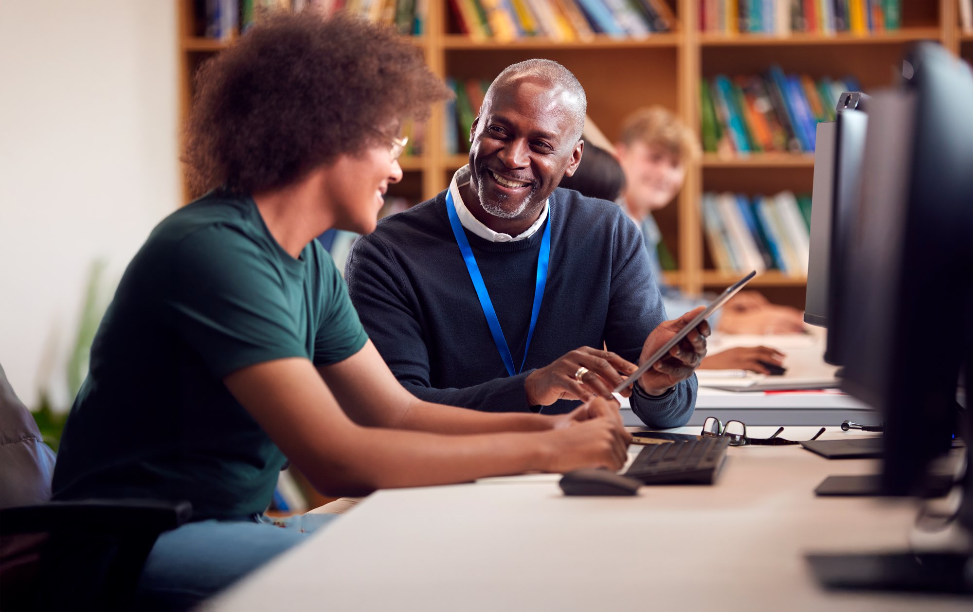 Male university student speaking with his mentor