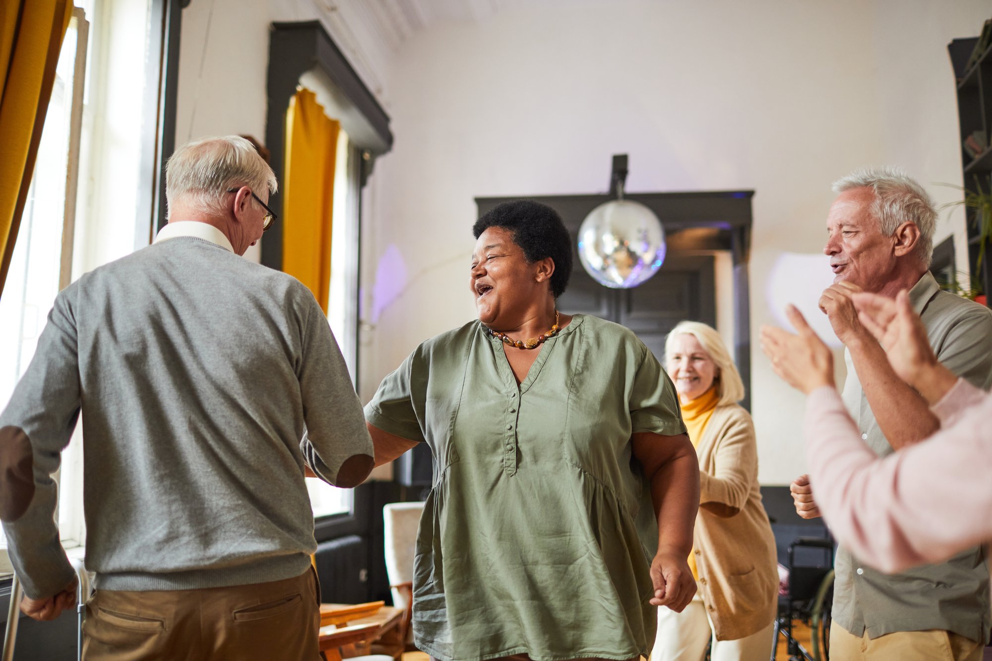 Senior citizens dancing in a community center
